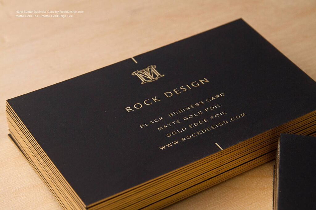 A black business card with gold engravings